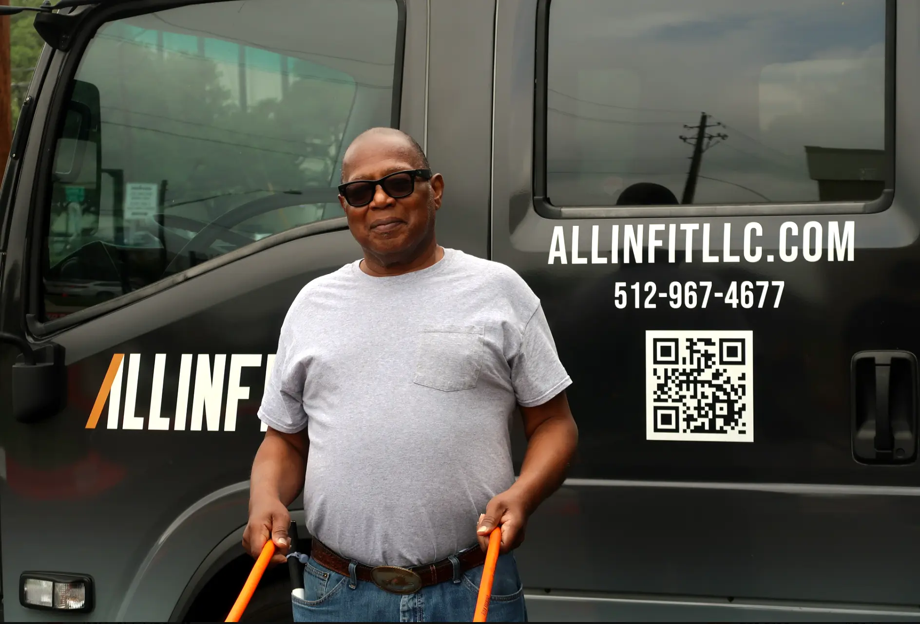 A participant using a resistance band in front of the mobile gym